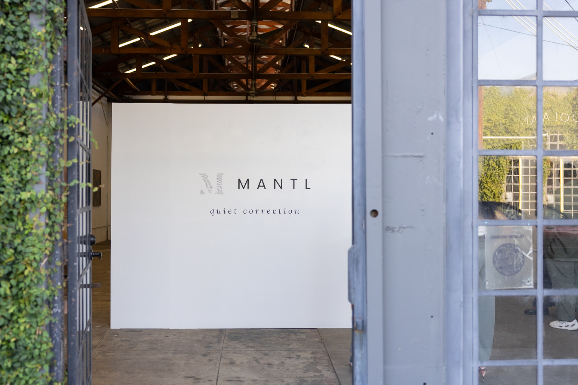 The entrance wall at Quiet Correction I, Los Angeles, with the MANTL logotype and exhibition title